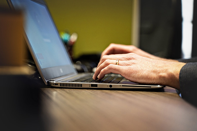 hands typing on a laptop